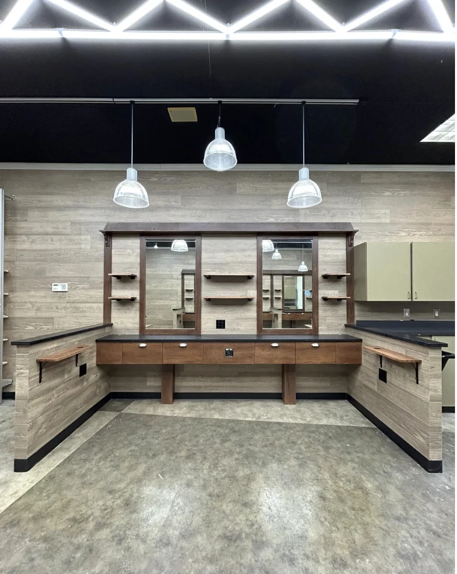 Custom barber stations with mirrors, shelving and millwork completed by HQ Construction & Remodeling