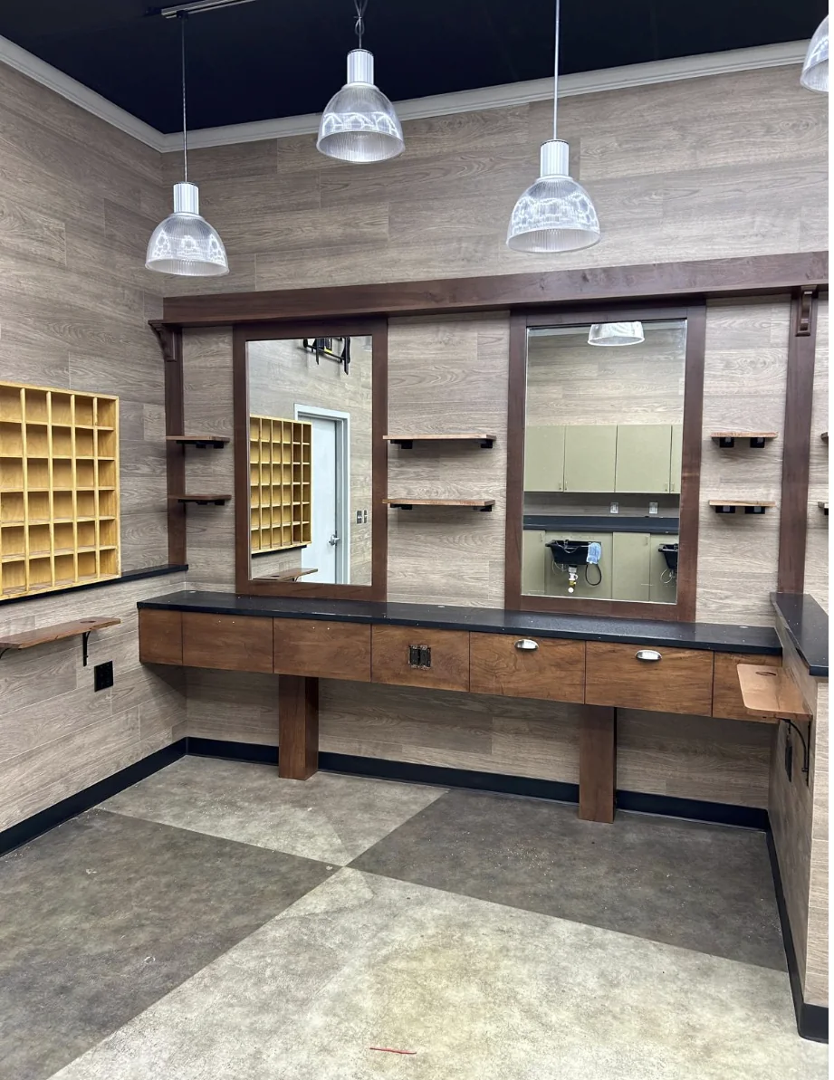 Custom barber workstation with mirror and cabinetry completed by HQ Construction & Remodeling