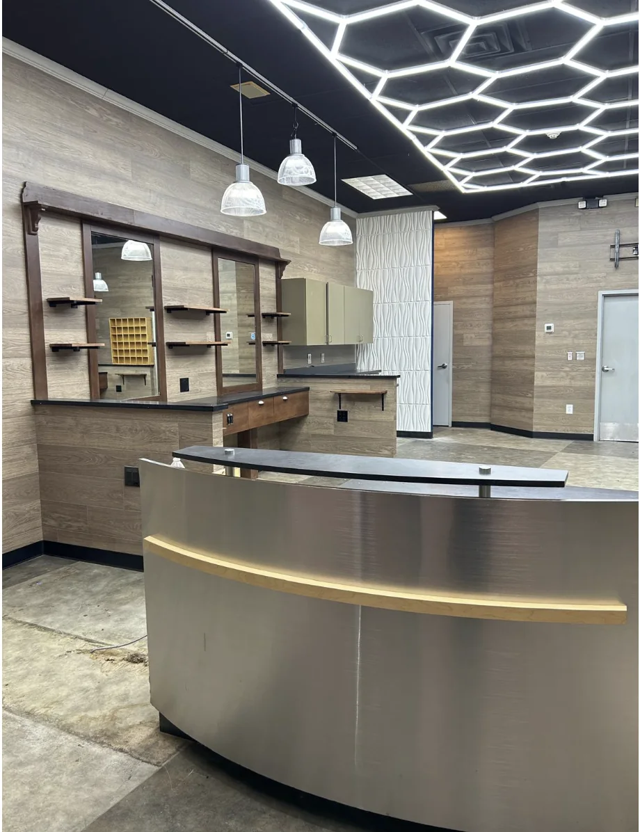 Barber shop reception counter and custom wall stations completed by HQ Construction & Remodeling