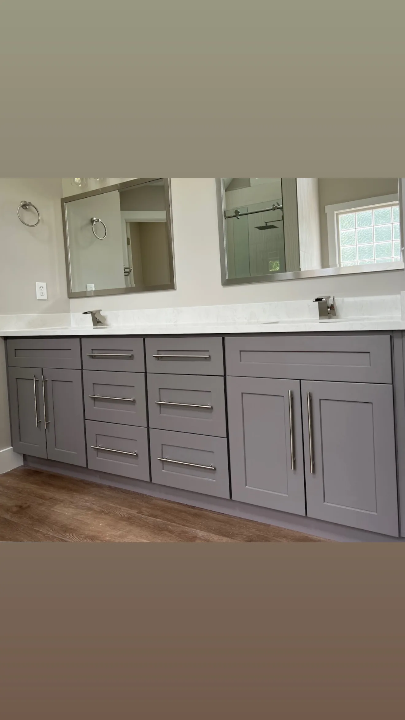 Bathroom remodeling project by HQ Construction & Remodeling with double vanity cabinetry and mirrors